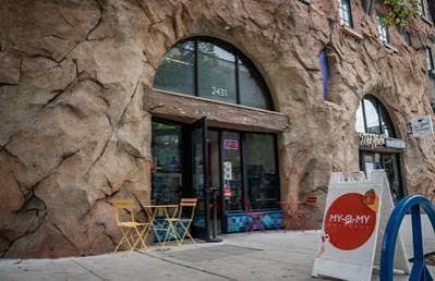 The Telegraph Avenue shopfront, with tables out front and the My-O-My sign on the pavement
